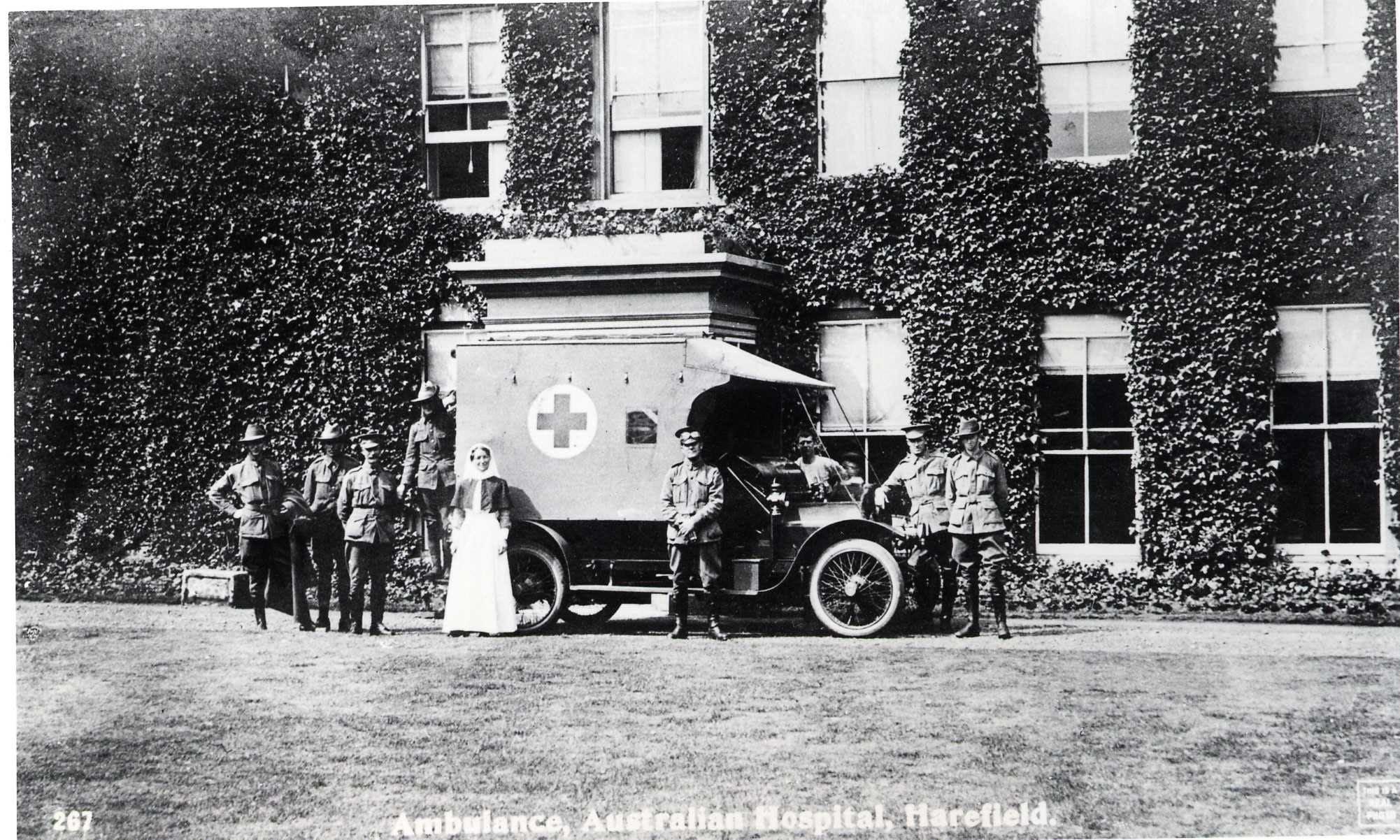 Black and white image of an ambulance, nurse and soldiers during the First World War